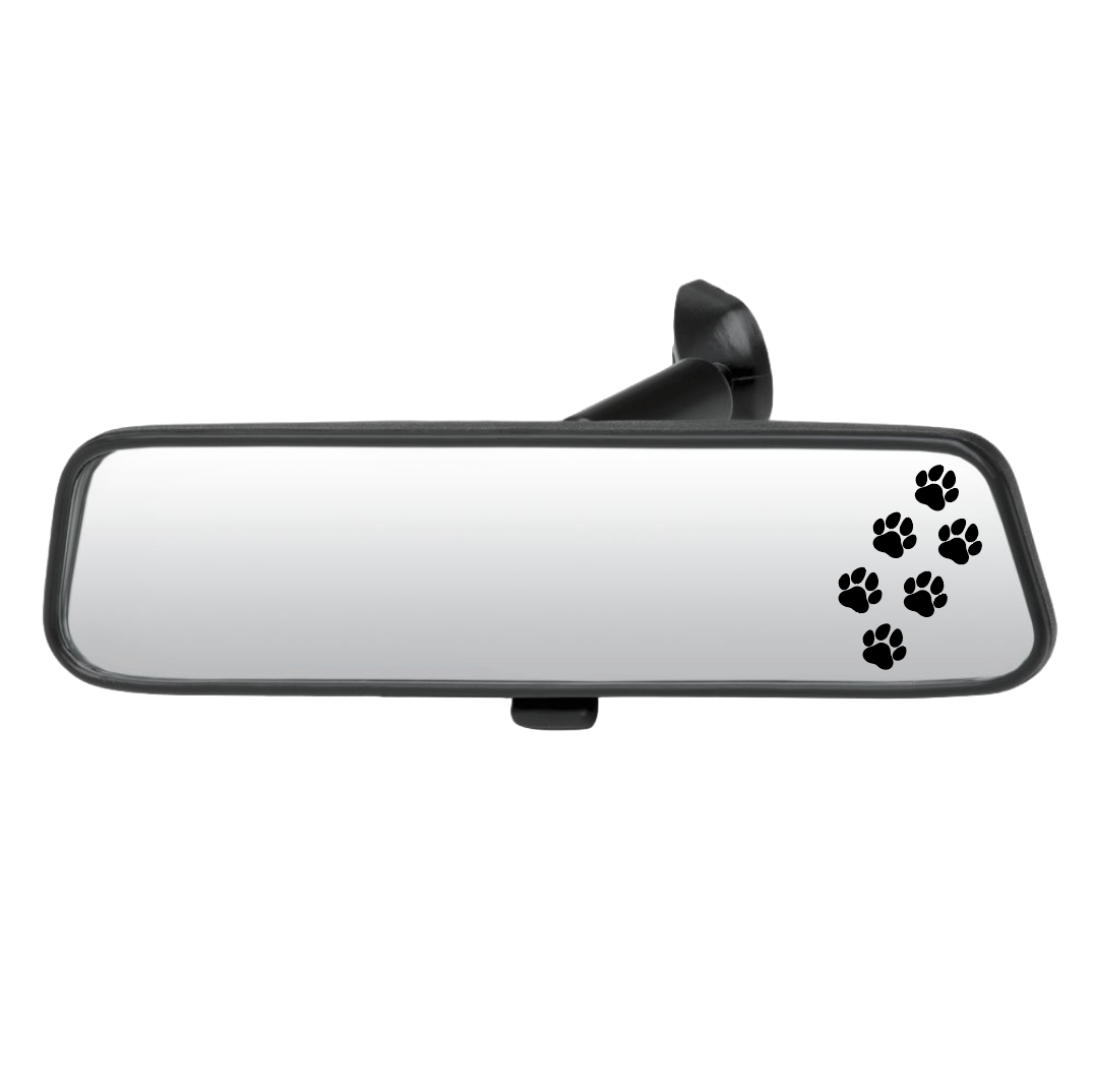 Car rearview mirror with black paw prints on a white background