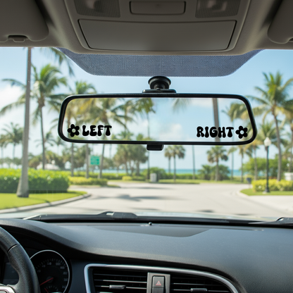 Car interior with a rearview mirror labeled 'LEFT' and 'RIGHT' with palm trees and a clear sky outside.