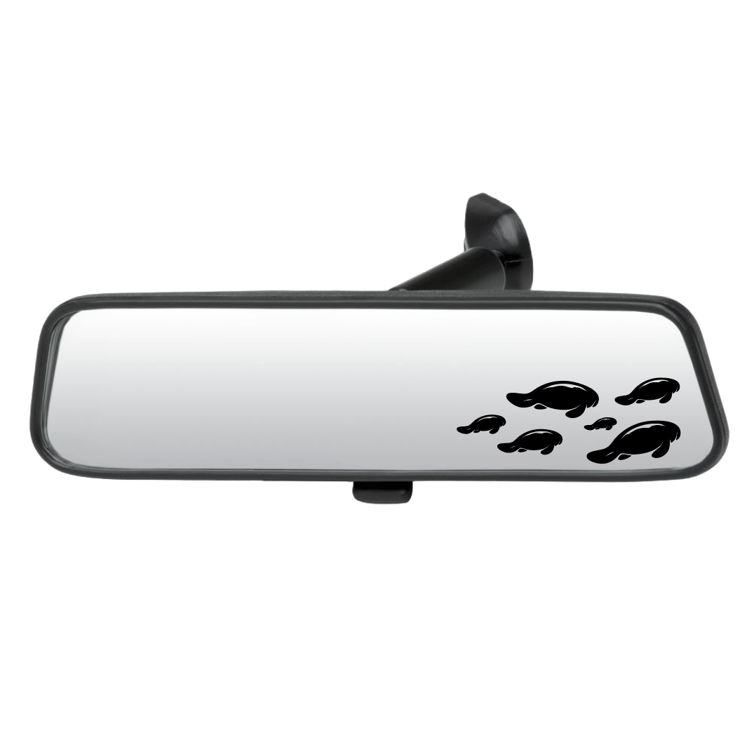 Car rearview mirror with manatee decals on a white background