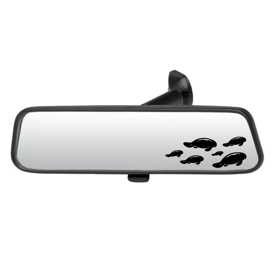 Car rearview mirror with manatee decals on a white background
